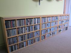 an entertainment center with many different types of dvd's