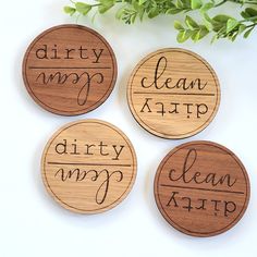 four wooden coasters that say dirty, clean, and happy on them with handwritten words