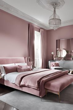 a bedroom with pink walls and furniture