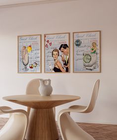 two framed pictures hang on the wall above a dining room table with chairs and a vase