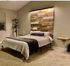 a bed sitting in a bedroom next to a wooden headboard on top of a wall