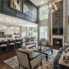 a living room filled with furniture and a fire place in front of a tv mounted on the wall