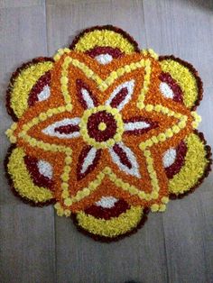 an orange and yellow flower on the ground