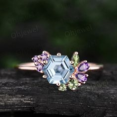 "This is a Hexagon 6x6mm  1ct natural aquamarine engagement ring in solid gold,  The accent stones are natural peridot and amethyst. The band width is about 1.4mm. It can be made in any ring size. However please contact me to custom make it to a special big or small size. It can be made in white gold,rose gold or yellow gold with 14k or 18k. However for some people who are nickel allergic,I can also make it to 925 sterling silver to make you can wear it. The ring is handmade,very high quality! 30 days money back guarantee. Returns & Warranty 30-Day money back guarantee (starting from the day of delivery). \"Made to Order\" purchases qualify for our 30-day money back guarantee. The 30-day money back guarantee gives you time to make sure your purchase is perfect. If you need to  return it fo Hexagon Ring, March Birthstone Ring, Ring Cluster, Multi Gemstone Ring, Aquamarine Engagement Ring, Cluster Engagement Ring, Aquamarine Ring, March Birthstone, Aquamarine Rings