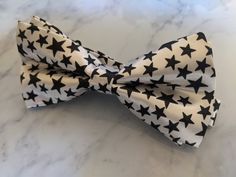 Upgrade your wardrobe in style with this stunning white bow tie featuring a unique black star pattern. Perfect gift for him, this adjustable bow tie will elevate your style for any occasion including weddings, birthdays and anniversaries. Comes pre-tied. White Bow Tie For Black-tie Events, White Adjustable Bow Tie For Black Tie Occasions, Adjustable White Bow For Black Tie Occasion, White Bow Tie, Burgundy Floral, Perfect Gift For Him, White Bow, Star Pattern, Tie Accessories