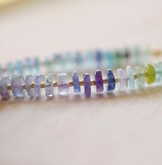 Fluorite is said to absorb and neutralize negative energy & stress. It is also believed to increase concentration, self-confidence, and help in decision-making. This bracelet is handcrafted with genuine Fluorite ranging blues, greens, and purples. Each stone is slightly different in width and has a tiny gold or silver bead between. STONE SIZE: 6mm SIZING: Please measure your wrist to find your size before purchasing. If purchasing as a gift the adjustable size of 6.5 to 7.5" fits most average wo Fusion Style Gemstone Beaded Bracelets For Healing, Fusion Style Healing Bracelets With Gemstone Beads, Fluorite Gemstone Beads Bracelets For Healing, Adjustable Fluorite Bracelets For Healing, Fluorite Bracelets, Fluorite Gemstone Beads Bracelet For Healing, Silver Fluorite Gemstone Jewelry, Purple Fluorite Gemstone Bead Jewelry, Purple Fluorite Gemstone Jewelry