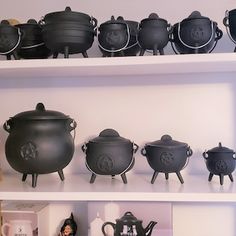 pots and pans sit on shelves in a room filled with books, figurines and other items