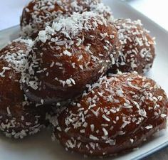 there are several donuts covered in coconut on the plate