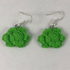 the earrings are made out of green leafy material