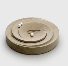 a wooden object with two pearls on it