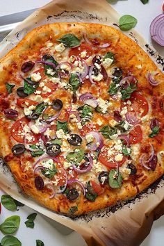 a pizza sitting on top of a pan covered in cheese and veggie toppings