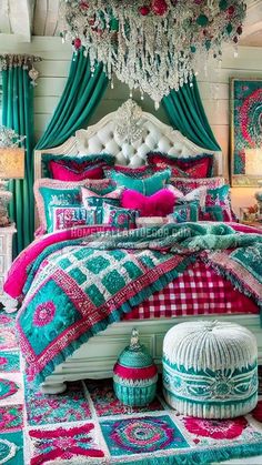 a bedroom decorated in turquoise, pink and white with a chandelier hanging from the ceiling