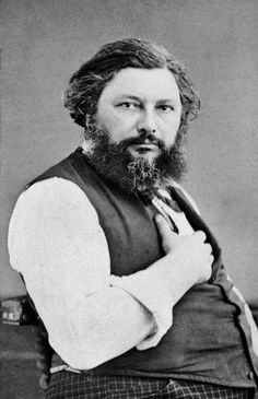 an old black and white photo of a man with a long beard wearing a vest