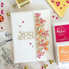 an assortment of crafting supplies on a white table with confetti and paper