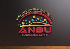 the logo for anbu automobile care is displayed on a wall next to a wooden table