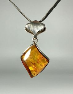 Elevate your jewelry collection with our stunning Genuine Amber Pendant, featuring a spectacular color and weighing 9,1 grams, set in high-quality 925 Sterling Silver. This exquisite pendant is designed especially for women who appreciate unique, handcrafted jewelry that combines elegance with the natural beauty of amber. Key Features: Authentic Baltic Amber: Our pendant showcases genuine Baltic amber, renowned for its stunning and unique color, adding a touch of natural elegance to any outfit. Silver Baltic Amber Necklace With Polished Finish, Elegant Amber Sterling Silver Necklace, Formal Baltic Amber Pendant Jewelry, Unique Silver Baltic Amber Jewelry, Baltic Amber Pendant Jewelry With Polished Finish, Polished Baltic Amber Pendant Jewelry, Baltic Amber Pendant With Polished Finish, Elegant Amber Jewelry With Polished Finish, Elegant Baltic Amber Jewelry In Orange