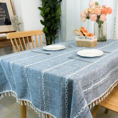 the table is set with plates and flowers