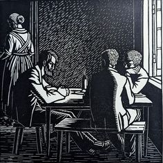 two people sitting at a table in front of a window, one person is writing