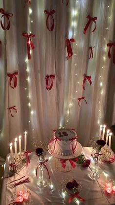 a table topped with a cake covered in candles