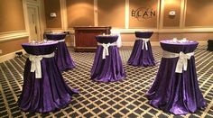 purple and white wedding decorations in the middle of a room