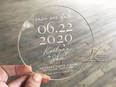 a person holding up a glass plate with the date on it