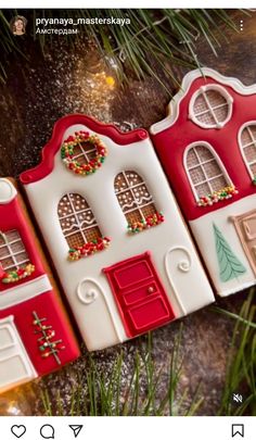 three gingerbread houses are hanging from a christmas tree