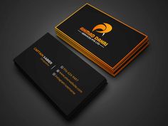 a black and gold business card with an orange logo on the front, sitting on a dark surface