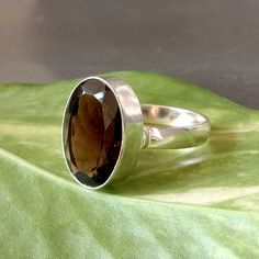 Smoky Quartz Ring, 925 Sterling Silver Ring, Oval Cut Smoky Ring, Natural Smoky Gemstone Silver Ring, Birthstone Gift Ring, Lovely Ring- New-01 Gemstone : Smoky Quartz Ring Size : Select Your Size Gemstone Shape : Oval Gemstone Dimension Approx : 16 x 12 mm Smoky quartz has a remarkable capacity to absorb and pull in negative energy and even though most of that is grounded into the earth, it is still a good idea to energetically cleanse your smoky quartz on a regular basis - you can do this by p Oval Faceted Rings In Fine Jewelry Style, Oval Faceted Crystal Promise Ring, Silver Faceted Oval Rings, Sterling Silver Ring With Large Oval Stone, Oval Sterling Silver Ring With Large Stone, Oval Sterling Silver Rings With Large Stone, Oval Faceted Rings For Anniversary, Oval Large Gemstones In Sterling Silver, Classic Sterling Silver Crystal Ring With Large Stone