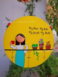 a yellow sign with a woman holding a cup and potted plant on it's side