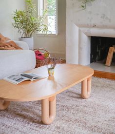 a living room with a couch, coffee table and fire place