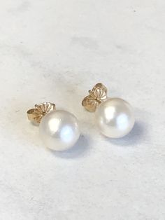 14kt Yellow Gold Lady's 9mm large Cultured Pearl Stud Earrings with beautiful round blemish free, cream/white color tones and hues with posts and friction backs. This Classic and Elegant Earrings are a statement item when worn. Pearl is the Birthstone for June. This item would Retail for $698.00 Classic White Pearl Earrings, Timeless Round 14k Gold Pearl Earrings, White 14k Gold Timeless Earrings, Timeless White 14k Gold Earrings, Classic White 14k Gold Earrings, Elegant Cream Earrings For Formal Occasions, Elegant Round 14k Stamped Earrings, Elegant 14k Stamped Earrings, Elegant Round 14k Gold Earrings