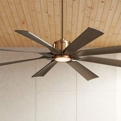 a ceiling fan with four blades in a room