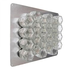 a metal wall mounted light with clear glass cubes