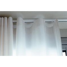 white curtains hanging on the side of a window