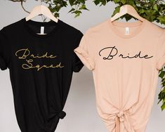 two t - shirts that say bride and bridesmaid on the front, one in black and one in pink