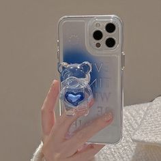 a clear case with a blue heart in the shape of a teddy bear on it