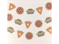 an assortment of desserts are hanging on a string with hearts and checkered bunting