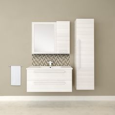 a white bathroom vanity with mirror and sink next to a wall mounted towel dispenser