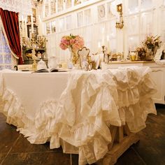 the table is covered with ruffled white cloth