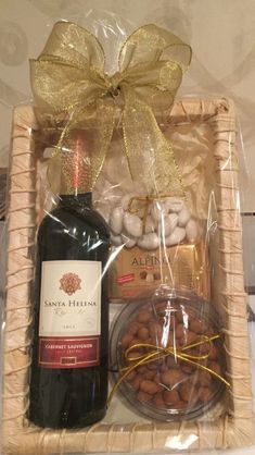 a bottle of wine and some nuts in a basket