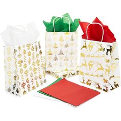 three paper bags with christmas designs on them, one is white and the other is red