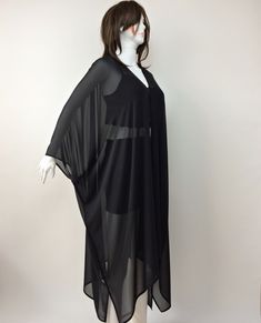 "This wonderful loose kimono is made of black silk georgette chiffon fabric. You can use this sheer plus-size cardigan with jeans or shorts. Also, it can wear as a beach cover-up on your swimsuit. This is a see-through sheer long jacket. Use it as casual wear. You will look fabulous when you wear this lightweight long caftan. This summer jacket would be a perfect gift for you or your loved ones. The boho solid kimono top is excellent, fun, and chic. It is a great gift for travel lovers. It is so Black Spring Kaftan For Evening Wear, Black Spring Evening Kaftan, Chic Black Long Sleeve Kaftan, Long Chiffon Kaftan For Evening, Flowy Long Sleeve Chiffon Kaftan, Chiffon Long Sleeve Kaftan For Evening, Long Sleeve Chiffon Kaftan For Evening, Flowy Chiffon Long Sleeve Kaftan, Black Long Kimono For Beach Cover-up