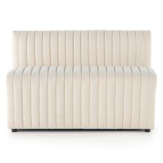 an upholstered white couch with black legs