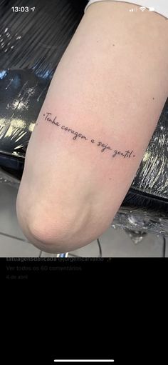 a person with a tattoo on their leg that says,'there comes you now '