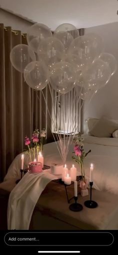 balloons and candles on a bed in a room