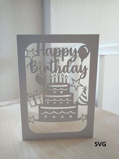 a card with a birthday cake cut out of it's side on a table