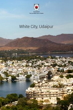 white city udaipur with mountains in the background and text overlay that reads, white city udaipur