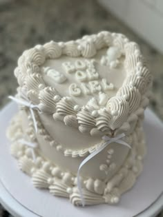 a heart shaped cake on top of a white plate with the word love spelled out