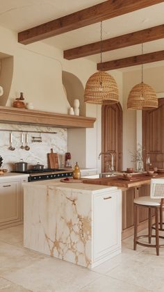 a large kitchen with marble counter tops and wooden beams on the ceiling, along with stools