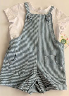 From Little Me, this is an infant jumper set. Size 12 months, two pieces--coveralls & top. Overalls are blue & white striped with back pockets, elastic back waist, snaps at crotch. Short sleeve white top has snaps in back. NEW WITH TAG..retail price $40. Baby & Toddler Clothing, White Top, White Tops, Two Pieces, 12 Months, Baby Toddler, White Stripe, Blue White, Overalls